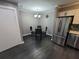 Dining area with a modern chandelier, round glass table, and stainless steel appliances at 2805 Ne Expressway Unit A24, Atlanta, GA 30345