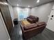 Comfortable living room with hardwood floors, brown leather sofas, and sliding glass doors at 2805 Ne Expressway Unit A24, Atlanta, GA 30345