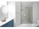 Bathroom with a double sink vanity, a round mirror, and a glass-enclosed shower at 2928 George Busbee Pkwy, Kennesaw, GA 30144