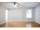 Spacious bedroom with hardwood flooring, large window, neutral paint, and ceiling fan with light at 2928 George Busbee Pkwy, Kennesaw, GA 30144