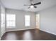 Bedroom with hardwood floors, large windows, a ceiling fan, and a closet at 2928 George Busbee Pkwy, Kennesaw, GA 30144