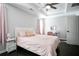 Bedroom with ceiling fan, tray ceiling, windows dressed with pink curtains, and gray walls at 2928 George Busbee Pkwy, Kennesaw, GA 30144