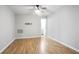 Cozy bedroom with hardwood floors, neutral paint, ceiling fan, and a TV mount for entertainment at 2928 George Busbee Pkwy, Kennesaw, GA 30144