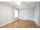 Comfortable bedroom with wood floors, neutral paint and ceiling fan, offering a serene living space at 2928 George Busbee Pkwy, Kennesaw, GA 30144