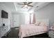 Bedroom features flat-screen TV, ceiling fan, neutral colored walls, and lots of natural light at 2928 George Busbee Pkwy, Kennesaw, GA 30144