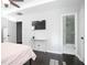 Bedroom boasts dark floors, flat-screen TV, and doorway to the shower in the ensuite bathroom at 2928 George Busbee Pkwy, Kennesaw, GA 30144