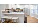 Eat in kitchen, white cabinets, stainless appliances, quartz countertops, and barstool seating at 2928 George Busbee Pkwy, Kennesaw, GA 30144