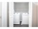 Laundry room with washer and dryer hookups with a white louvered door at 2928 George Busbee Pkwy, Kennesaw, GA 30144