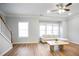 Bright living room with hardwood floors, a ceiling fan, and lots of natural light at 2928 George Busbee Pkwy, Kennesaw, GA 30144