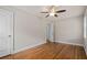 Bedroom with hardwood floors, ceiling fan, neutral paint, one window and two white doors at 3153 Bonway Dr, Decatur, GA 30032