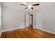 Bedroom with hardwood floors, ceiling fan, neutral paint, and two white doors at 3153 Bonway Dr, Decatur, GA 30032