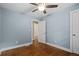 A lovely bedroom with hardwood floors, ceiling fan and a light blue paint at 3153 Bonway Dr, Decatur, GA 30032