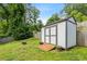 Backyard shed with double doors and gray trim at 3153 Bonway Dr, Decatur, GA 30032