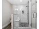 Elegant glass-enclosed shower featuring a tiled bench, river rock floor, and sleek fixtures for a spa-like experience at 3153 Bonway Dr, Decatur, GA 30032