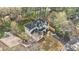 A bird's-eye view of a charming home with a long driveway, fenced yard, and beautiful surroundings at 3444 Underwood Se Ct, Conyers, GA 30013