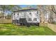 This home has a spacious backyard and a dark deck, complete with a newly installed wooden fence at 3444 Underwood Se Ct, Conyers, GA 30013