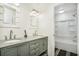 Bathroom with double vanity, granite countertop, framed mirrors, and tile flooring leading to shower/tub combo at 3444 Underwood Se Ct, Conyers, GA 30013
