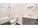 This bathroom offers a shower-tub combo and stylish vanity with round mirror and modern faucet at 3444 Underwood Se Ct, Conyers, GA 30013