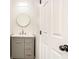 This stylish bathroom features a modern vanity with a marble countertop and a round mirror at 3444 Underwood Se Ct, Conyers, GA 30013
