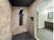 Shower with stone-look tiled walls and a modern shower panel, adjacent to a bathroom with a vanity at 3444 Underwood Se Ct, Conyers, GA 30013