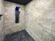 Modern shower featuring stone-look tile, a sleek shower panel, and a unique stone pebble floor at 3444 Underwood Se Ct, Conyers, GA 30013