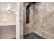 Shower with modern shower panel and unique stone-look tiling, open to adjacent bedroom at 3444 Underwood Se Ct, Conyers, GA 30013