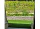 A view from a covered patio, of the backyard and the tiered retaining wall behind it at 4180 Cavalier Way, Duluth, GA 30097