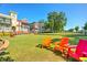 Grassy community area with outdoor seating and nearby townhomes at 4180 Cavalier Way, Duluth, GA 30097