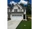 Charming two-story home with a two-car garage and well-manicured lawn at 4180 Cavalier Way, Duluth, GA 30097