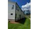 Side view of a townhome featuring white siding and well-maintained landscaping at 4180 Cavalier Way, Duluth, GA 30097