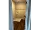 Dedicated laundry room has hardwood floors, wire shelving, and space for a washing machine at 4180 Cavalier Way, Duluth, GA 30097