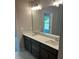 Main bathroom features a dual vanity, a large mirror and a door into the restroom area at 4180 Cavalier Way, Duluth, GA 30097