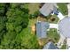 Aerial view of a home featuring a large lawn and mature trees at 4613 Creek Forest Ct, Lilburn, GA 30047