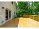 Sunny back deck with a wood surface, door to the house, and space for outdoor furniture at 4613 Creek Forest Ct, Lilburn, GA 30047