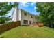 Spacious backyard with a patio, wooden fence, and lush green lawn and mature trees at 4613 Creek Forest Ct, Lilburn, GA 30047