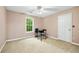 Cozy bedroom with natural light from the window and neutral color scheme at 4613 Creek Forest Ct, Lilburn, GA 30047