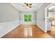 Dining room features hardwood floors, crown molding, and a bright window at 4613 Creek Forest Ct, Lilburn, GA 30047