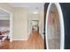 Welcoming foyer with hardwood floors and decorative glass front door, leading to the kitchen at 4613 Creek Forest Ct, Lilburn, GA 30047