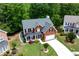 Charming two-story brick home with a well-manicured front yard, two-car garage, and covered porch at 4613 Creek Forest Ct, Lilburn, GA 30047