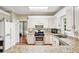 Bright kitchen features white cabinetry, granite countertops, and stainless steel appliances at 4613 Creek Forest Ct, Lilburn, GA 30047