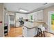 Bright kitchen featuring white cabinetry, granite countertops, and stainless steel appliances at 4613 Creek Forest Ct, Lilburn, GA 30047