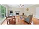 Comfortable living room features hardwood flooring, a fireplace, and plenty of natural light at 4613 Creek Forest Ct, Lilburn, GA 30047