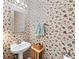 Quaint powder room with pedestal sink and floral wallpaper at 4613 Creek Forest Ct, Lilburn, GA 30047