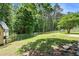 Backyard featuring grass, tree coverage, and a wood fence at 5427 Highway 81, Loganville, GA 30052