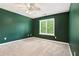 Cozy bedroom with carpeted floors, a ceiling fan, and natural light at 5427 Highway 81, Loganville, GA 30052