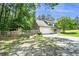 View of home showing fenced yard, tire swing, attached garage and traditional exterior with green lawn at 5427 Highway 81, Loganville, GA 30052