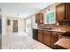 Efficient kitchen with wood cabinets, white floors and stainless steel appliances at 5427 Highway 81, Loganville, GA 30052