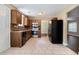 Functional kitchen featuring dark wood cabinets, tile floors, and stainless steel appliances at 5427 Highway 81, Loganville, GA 30052