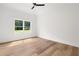Bedroom with wood floor and bright light from window with view of green outdoors at 2339 Eastwood Dr, Snellville, GA 30078