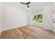 This bedroom features wood floors, neutral paint, and a bright window view at 2339 Eastwood Dr, Snellville, GA 30078